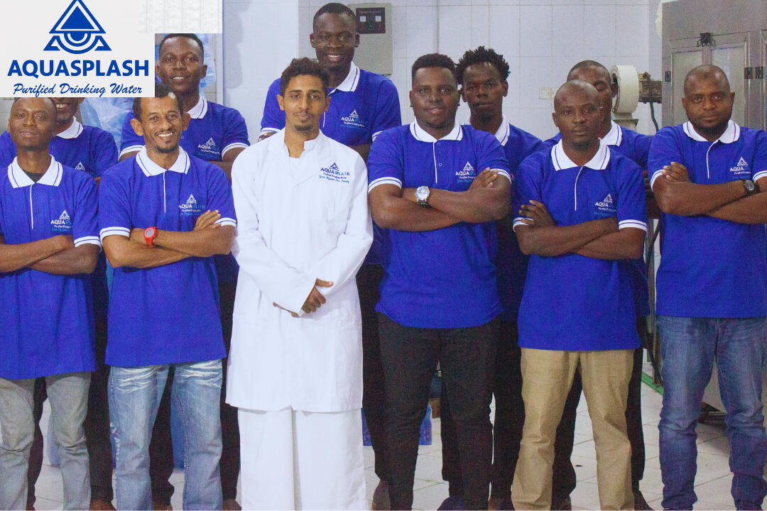 The AquaSplash Team standing together in uniform at our productiion facility in Mombasa